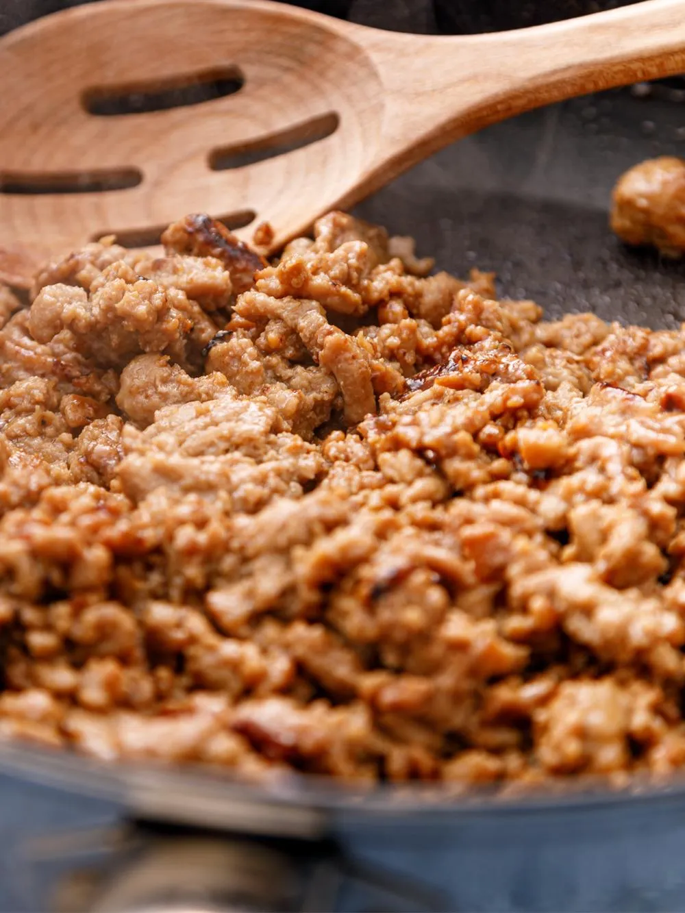 a skillet of cooking ground chicken for our chicken and green bean stir fry