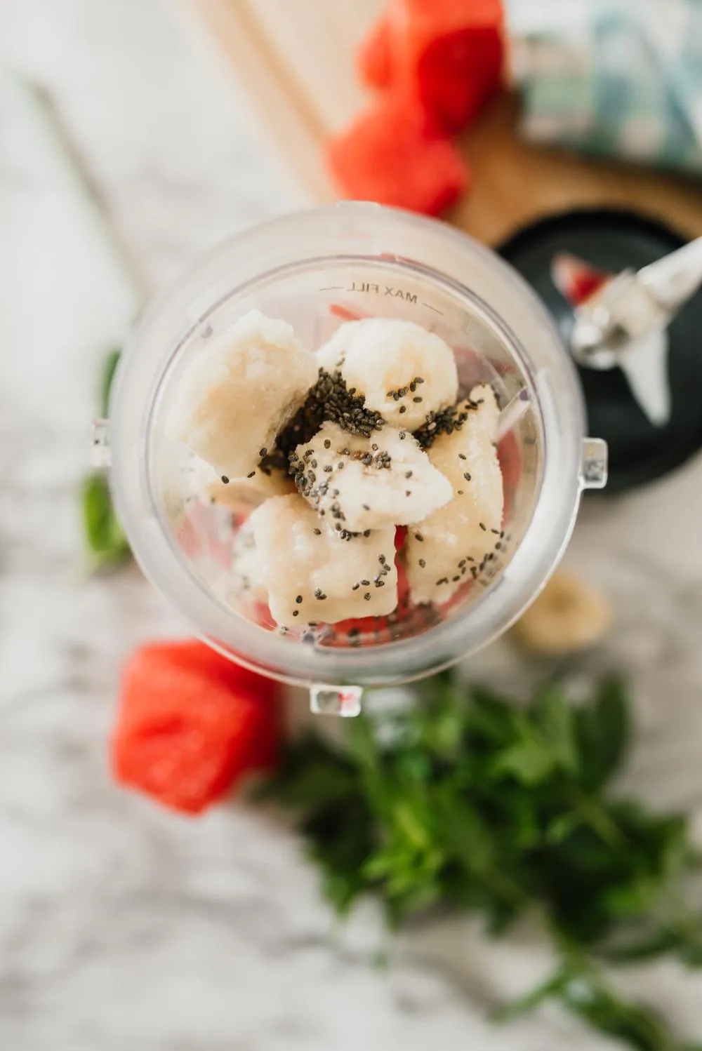 a small blender cup filled with the ingredients for a watermelon smoothie for weight loss 